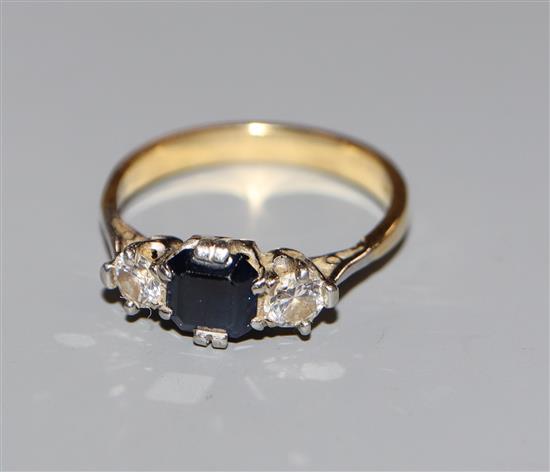 An 18ct and plat, sapphire and diamond set three stone ring, size S.